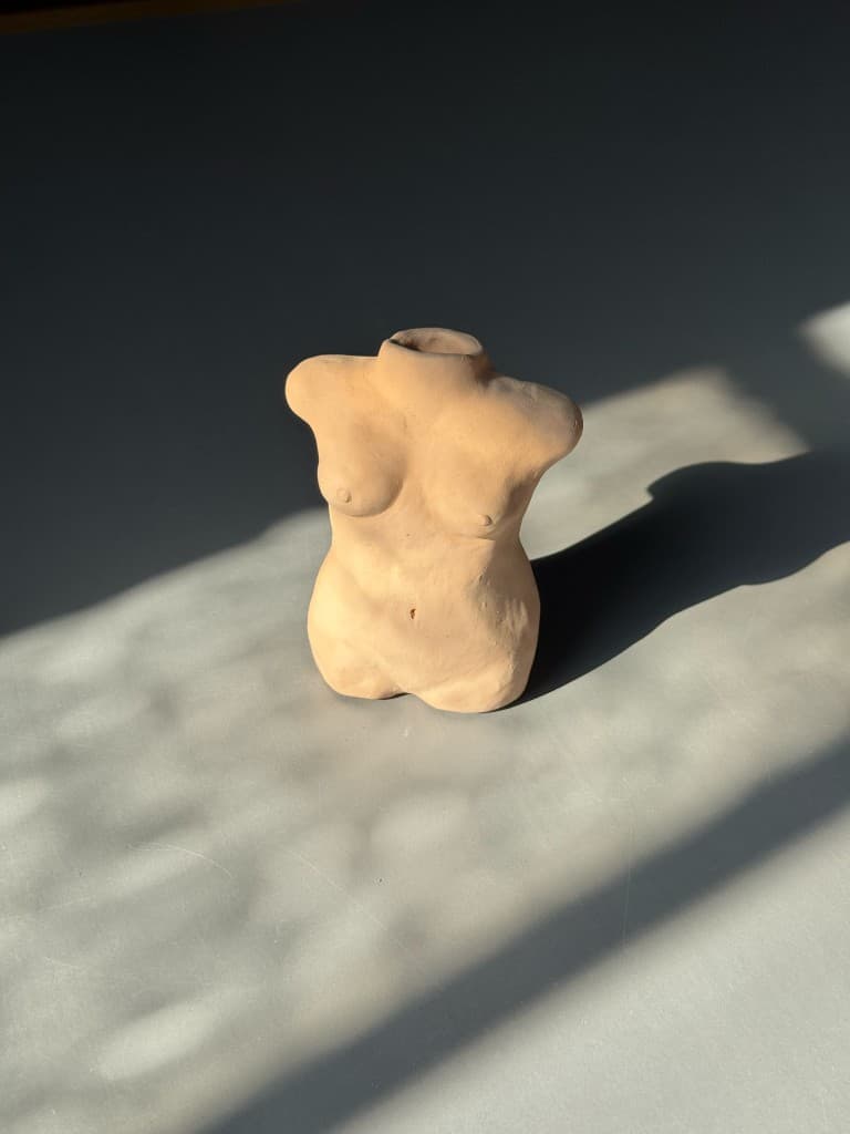 Lille keramikskulptur formet som en torso